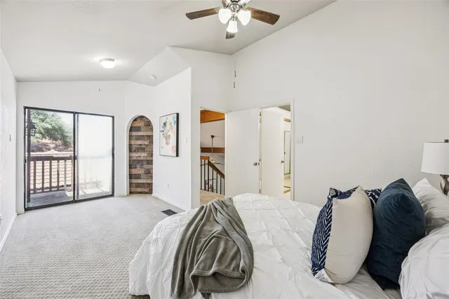 a spacious bedroom with a bed and a chandelier