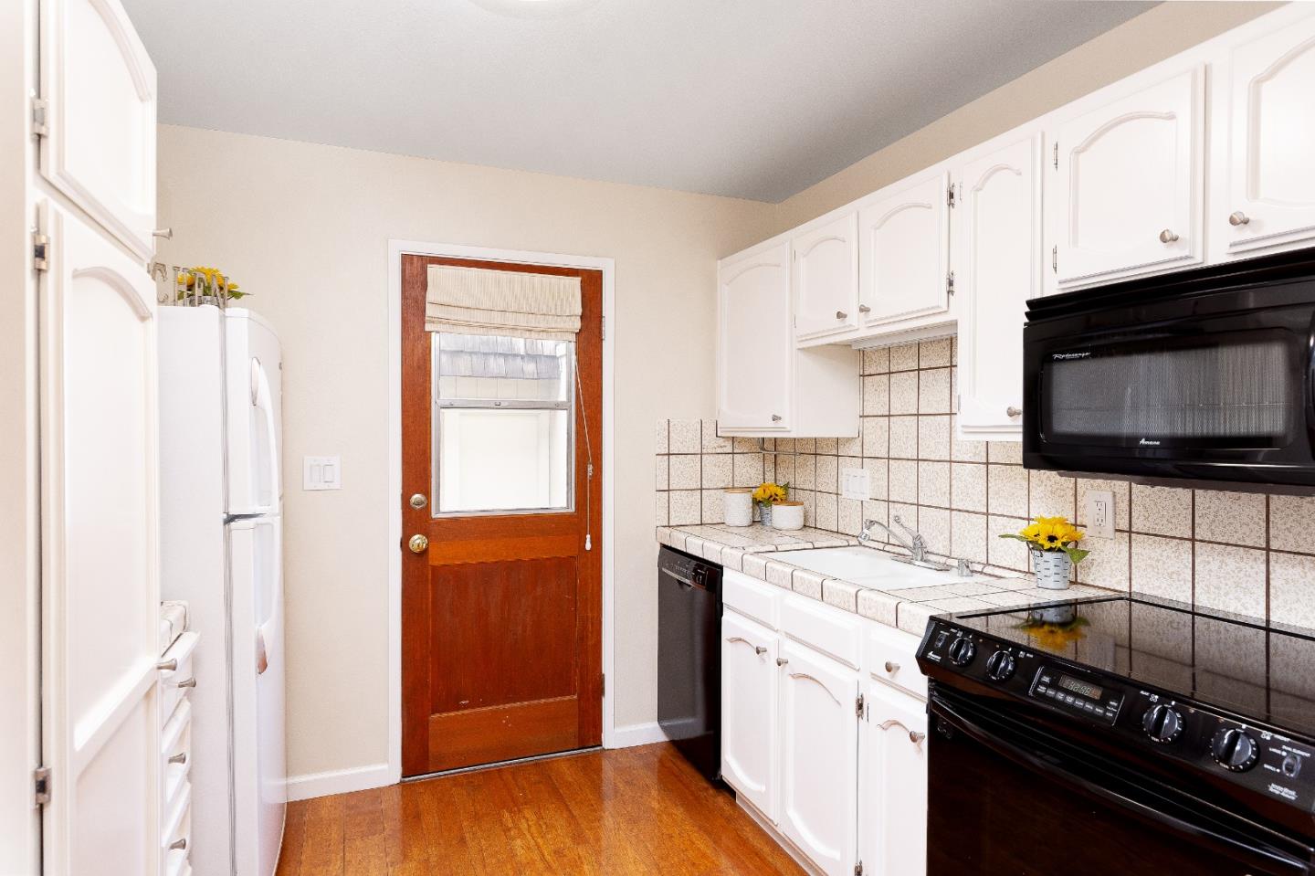 803 Curtis Street Menlo Park, CA 94025 - Photo 4 of 17 a kitchen with a sink stove and microwave