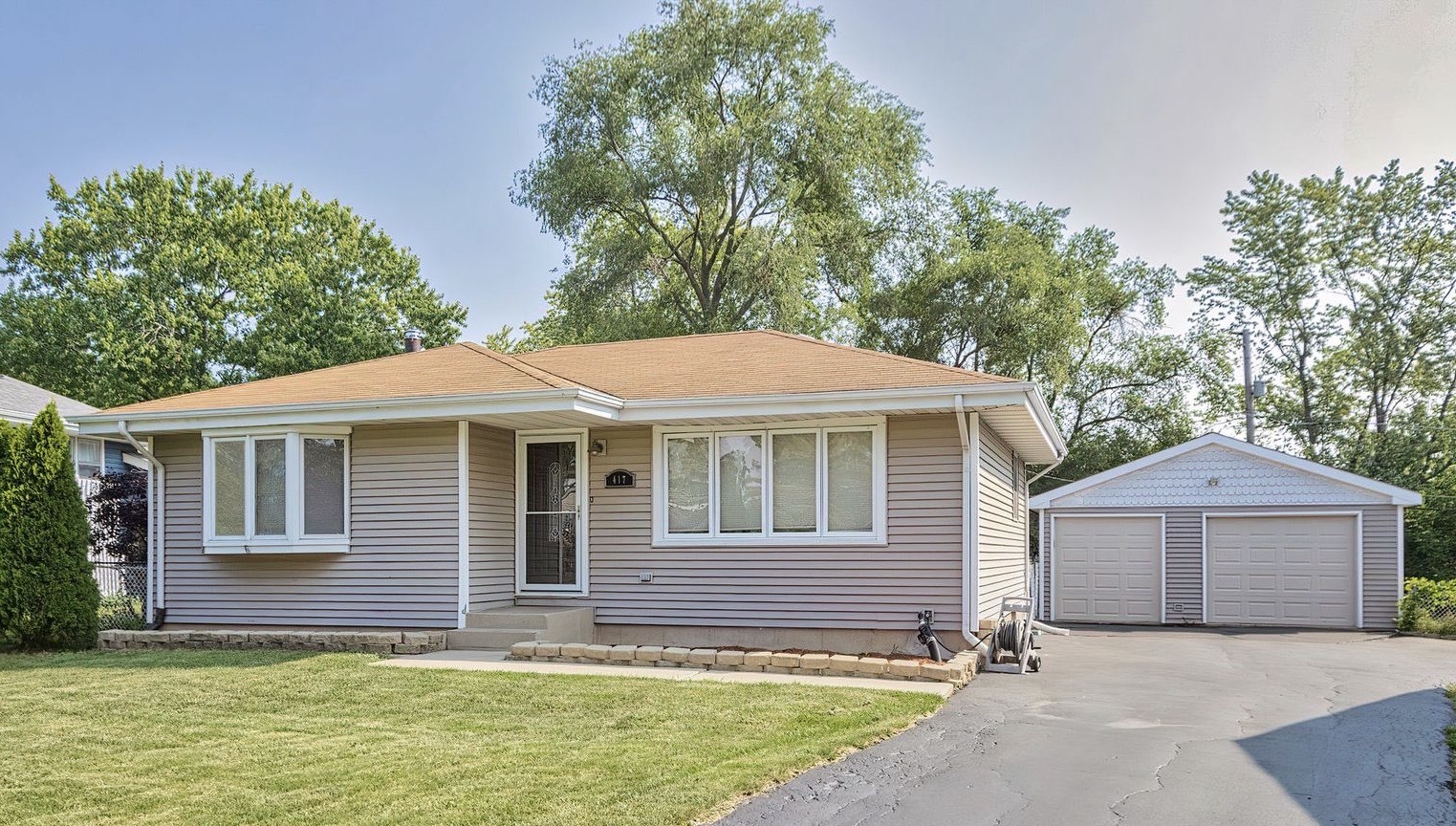 417 Deerpath Drive Lindenhurst, IL 60046 - Photo 2 of 23 a front view of a house with a yard and garage