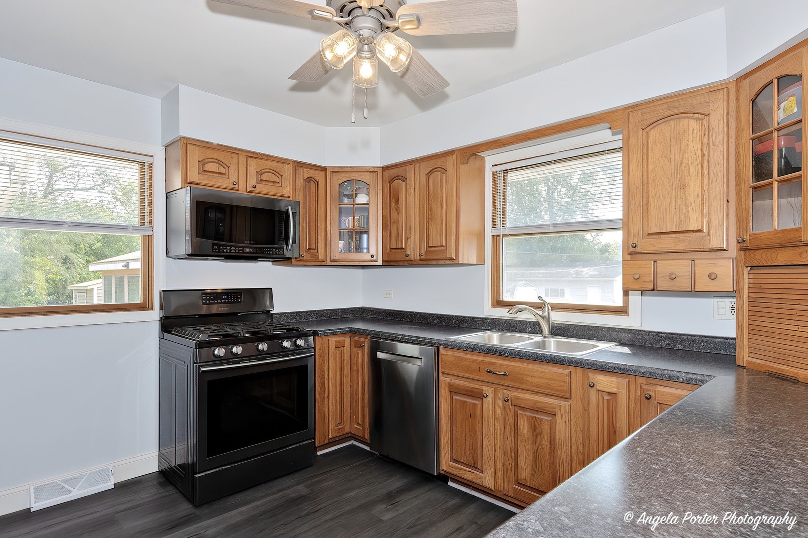 417 Deerpath Drive Lindenhurst, IL 60046 - Photo 5 of 23 a kitchen with stainless steel appliances granite countertop a stove a sink and a microwave