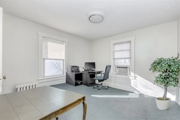 a workspace with furniture and a potted plant
