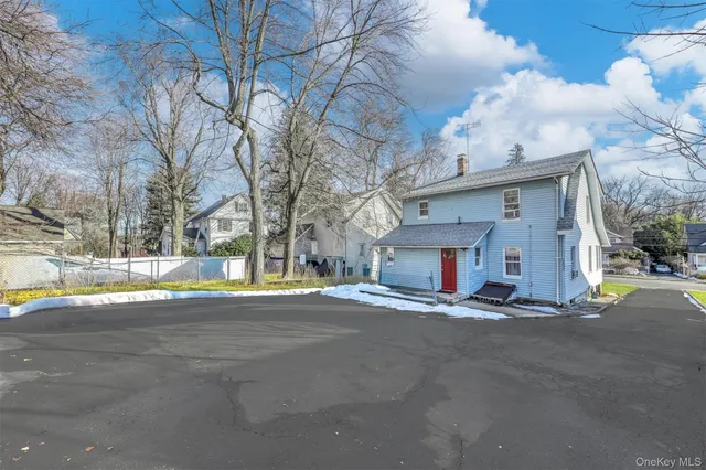 a view of the house with a snow and yard