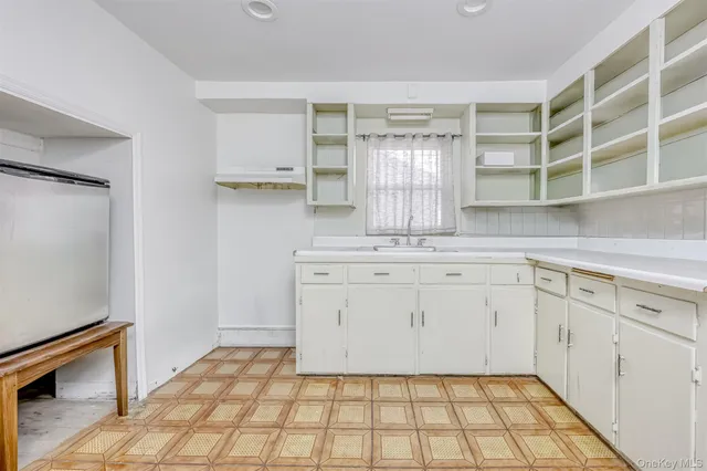 a room with a washing machine and cabinets