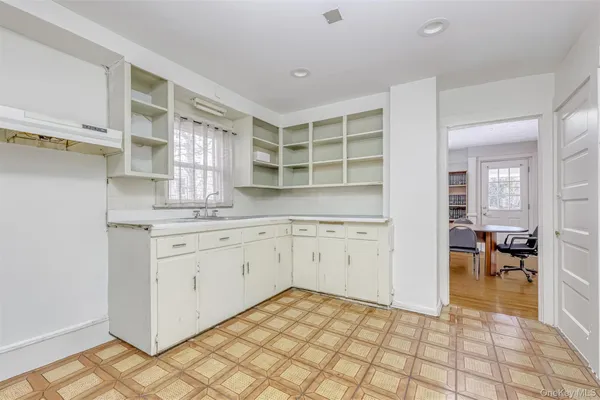 a kitchen with a sink a stove cabinets and counter space
