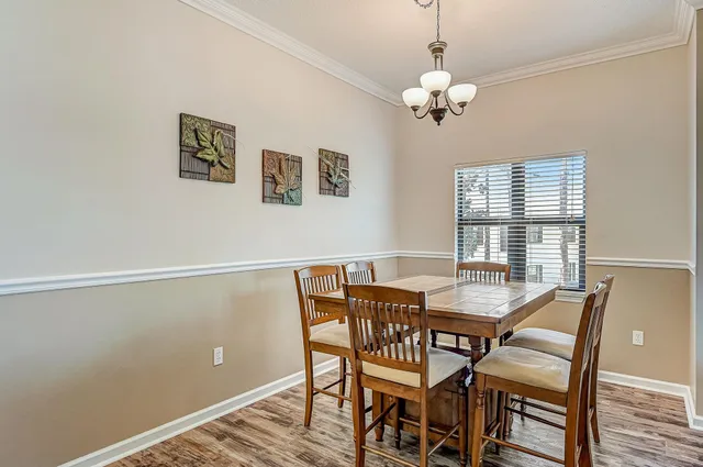 a view of a dining room with furniture wooden floor and a chandelier