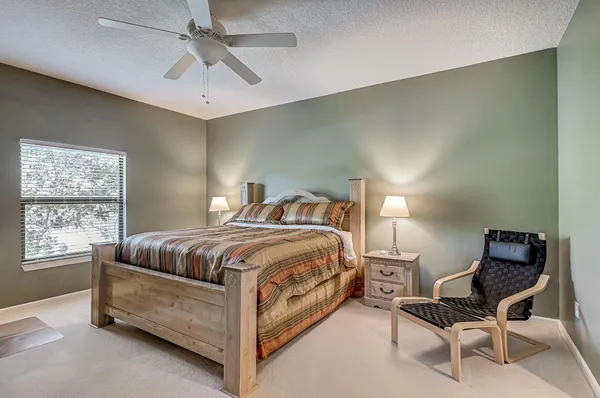 a bedroom with a bed and chair