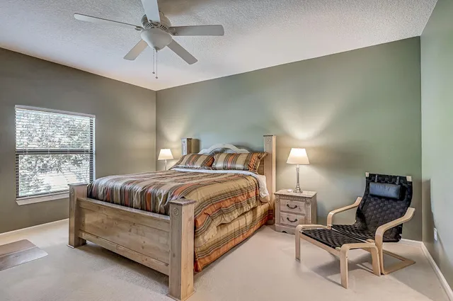 a bedroom with a bed and chair