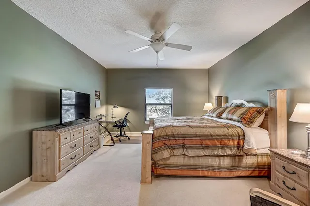 a bedroom with a bed and a tv