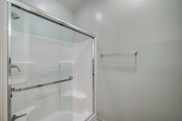 a bathroom with a glass shower door