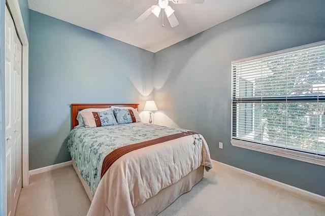 a bedroom with a bed and a large window