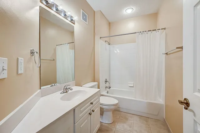 a bathroom with a sink toilet tub and shower