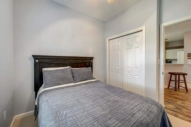 a bedroom with a bed and wooden floor