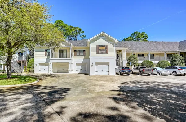 a view of a street with cars parked in front of it