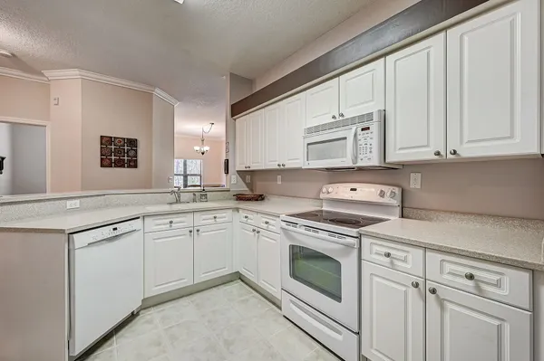 a kitchen with cabinets appliances and a window