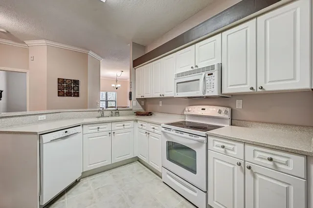 a kitchen with cabinets appliances and a window