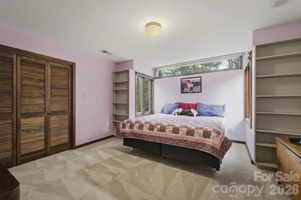 a bedroom with a bed and a closet