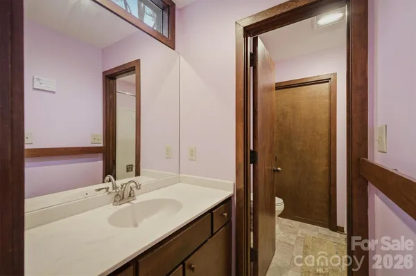 a bathroom with a sink a vanity and a mirror