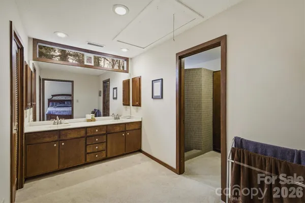 a spacious bathroom with a double vanity sink and a mirror