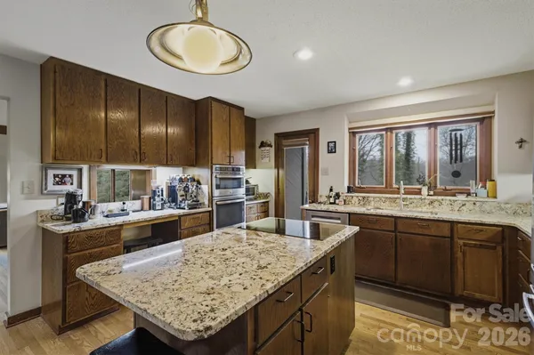 a kitchen with center island and stainless steel appliances