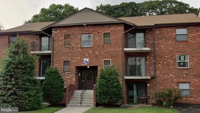 a front view of a house with plants