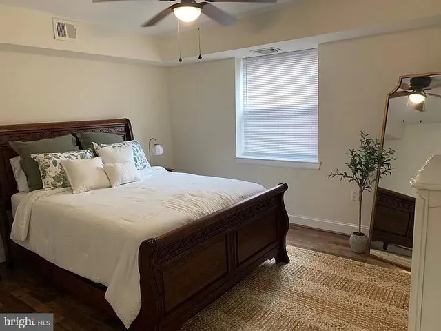 a bedroom with a bed and a potted plant