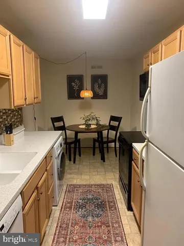 a kitchen with a sink appliances and cabinets