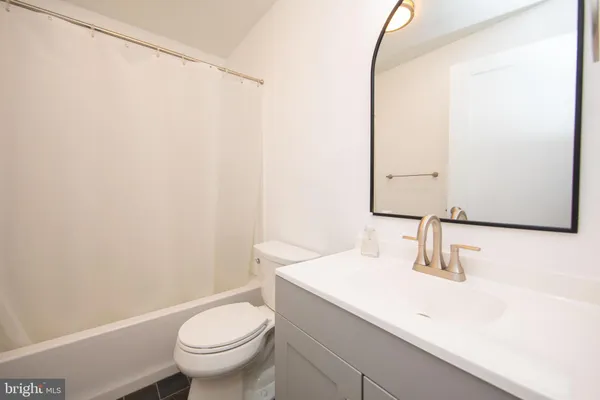 a bathroom with a sink a toilet and mirror