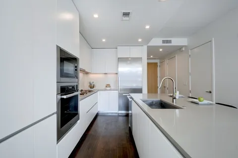 a kitchen with stainless steel appliances a sink stove and refrigerator