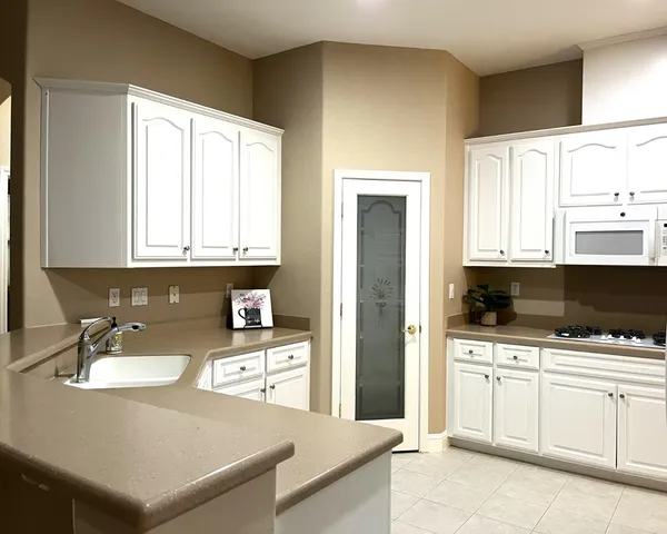 a kitchen with stainless steel appliances a stove a sink and a microwave