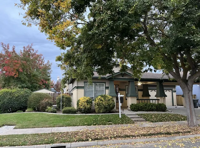 a front view of a house with a garden