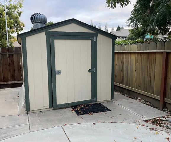 a view of a wooden house with a outdoor space