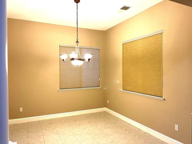 a view of a room with a window and ceiling fan
