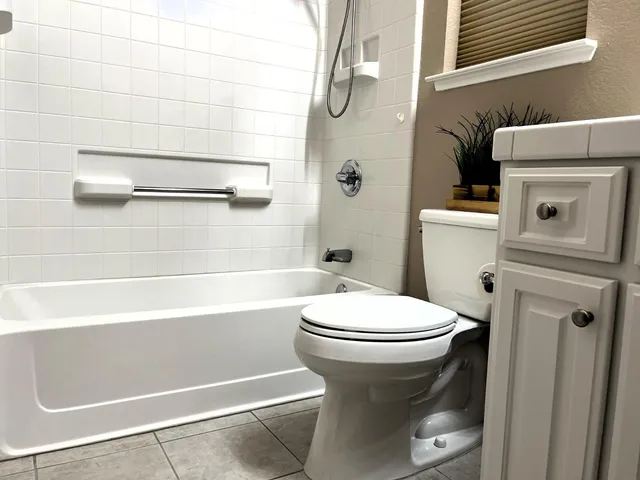 a bathroom with a toilet and a shower