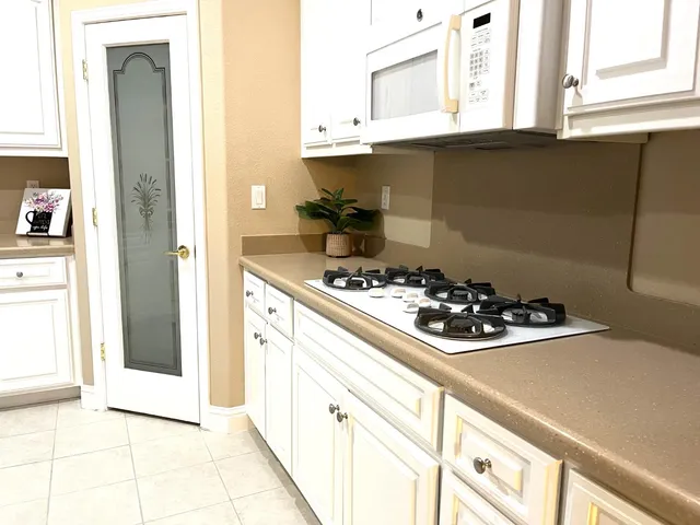 a kitchen with a sink a stove and cabinets