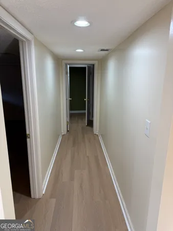 a view of hallway with wooden floor