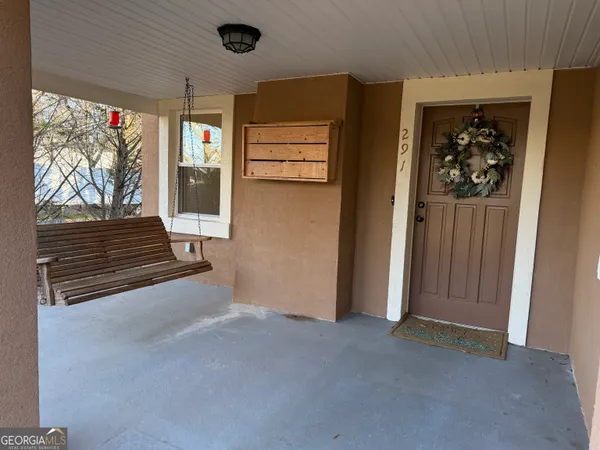 a view of a livingroom with wooden floor and windows