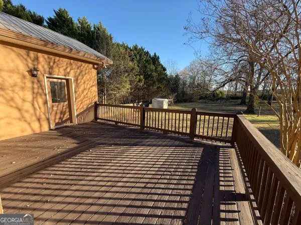 a view of a patio with wooden floor and fence