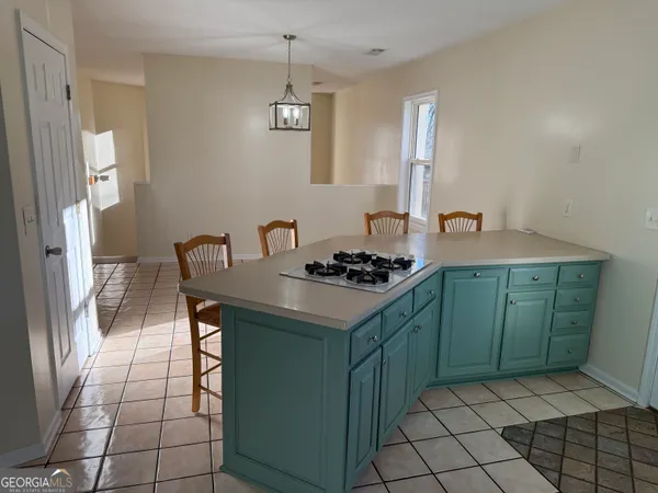 a kitchen with stainless steel appliances granite countertop a sink a stove a refrigerator and cabinets