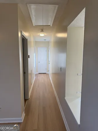 a view of a hallway with wooden floor