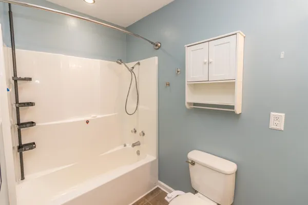 a bathroom with a shower a toilet and a shower