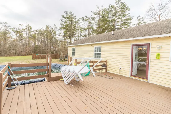 a view of a roof deck with table and chairs with wooden floor and fence