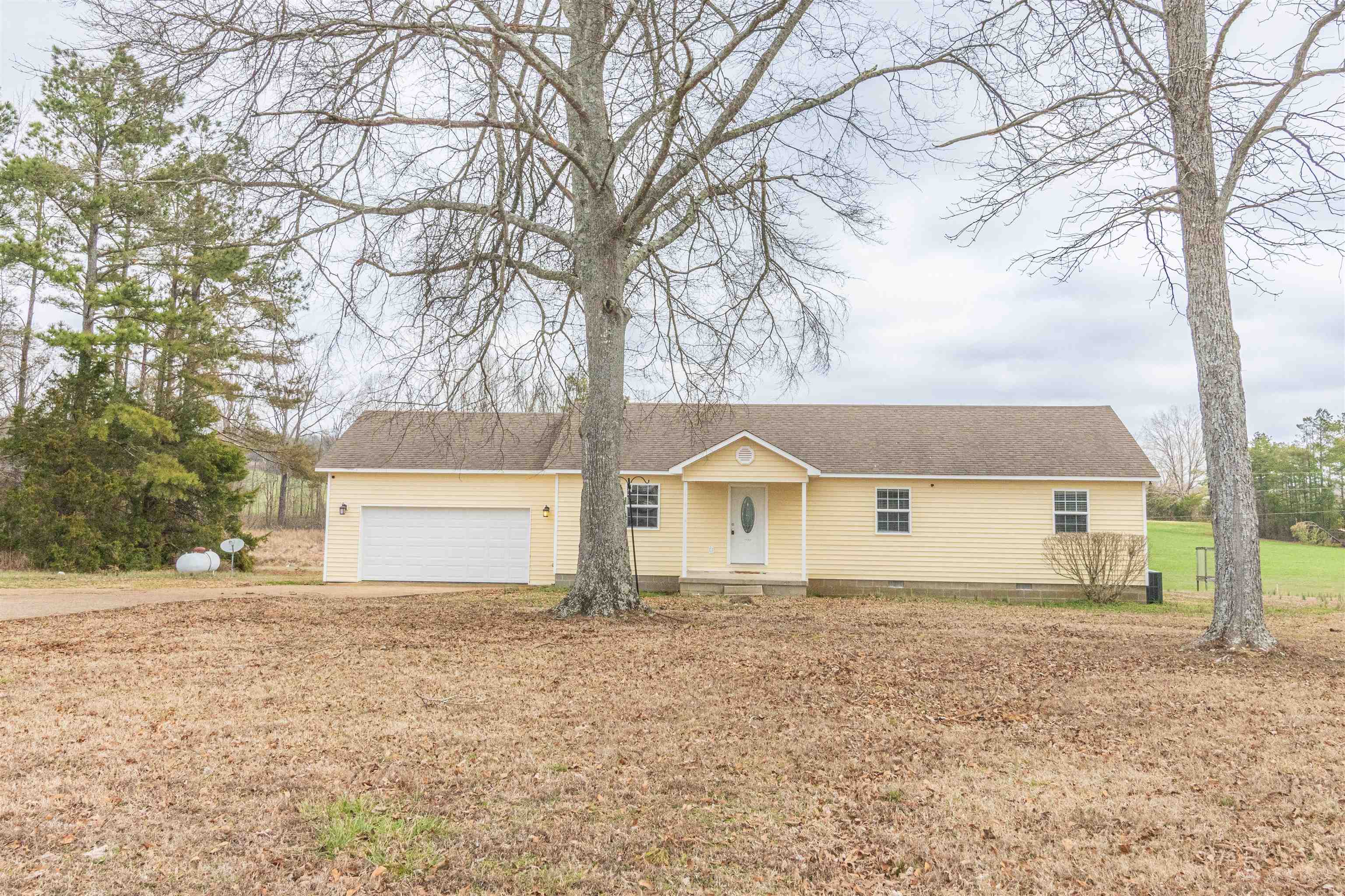 1468 Matrose Carroll Road Michie, TN 38357 - Photo 26 of 27 a white house that has a tree in front of it