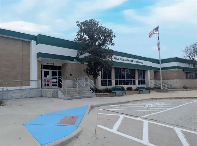 a view of a house with a patio and a yard