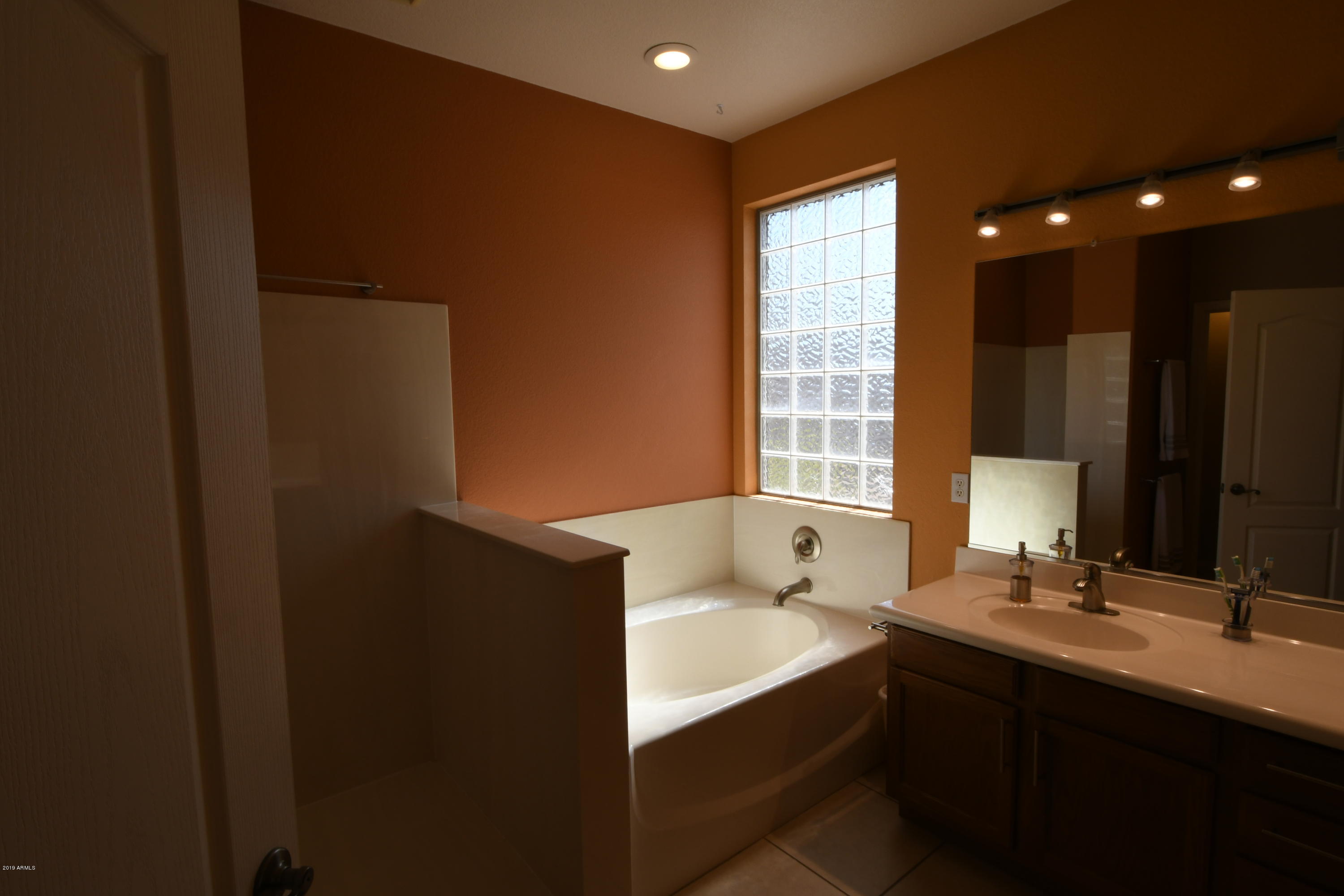 2226 West Carson Road Phoenix, AZ 85041 - Photo 15 of 29 a bathroom with a bathtub sink and mirror
