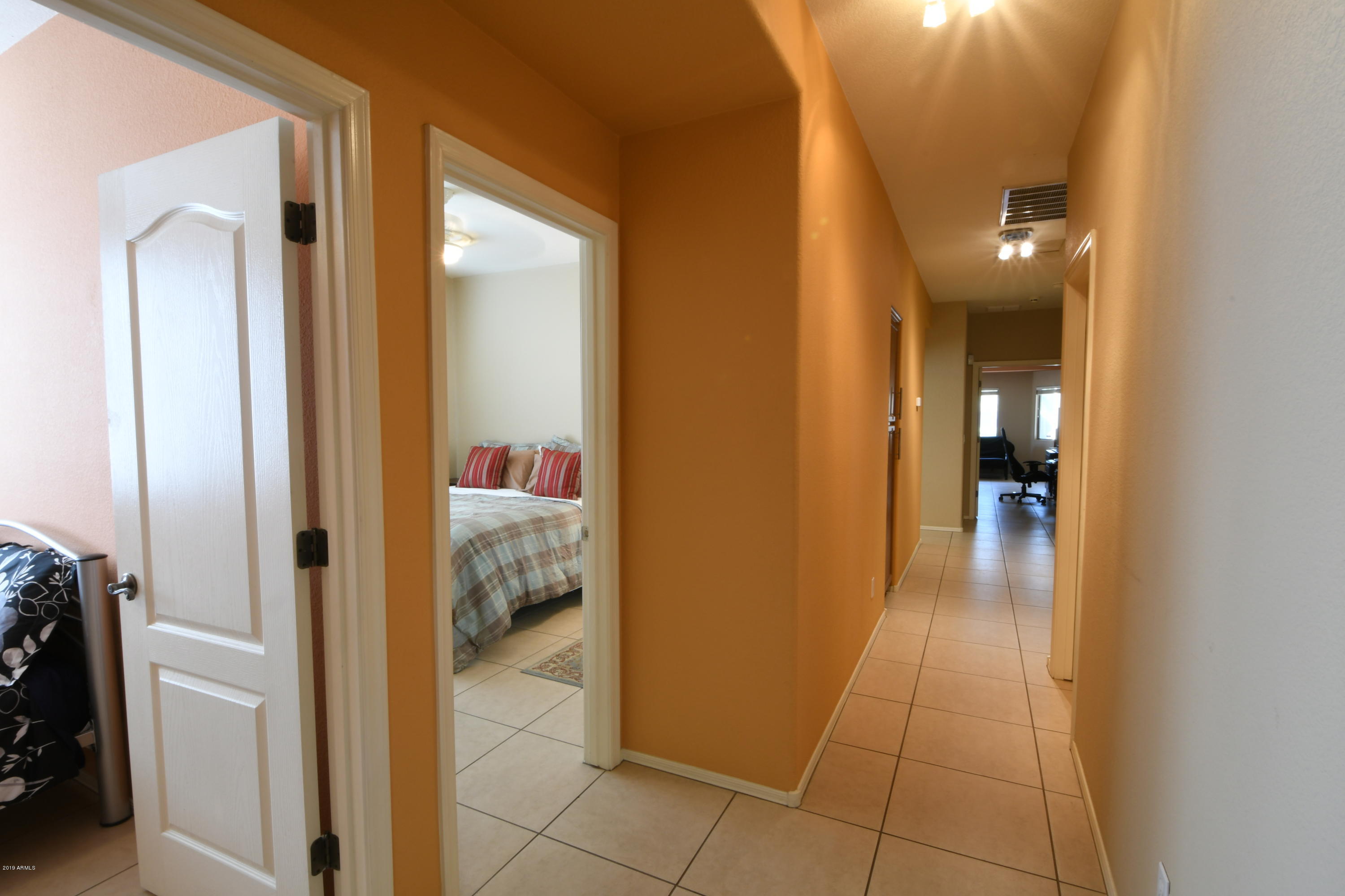 2226 West Carson Road Phoenix, AZ 85041 - Photo 18 of 29 a hallway with sliding door and bedroom view