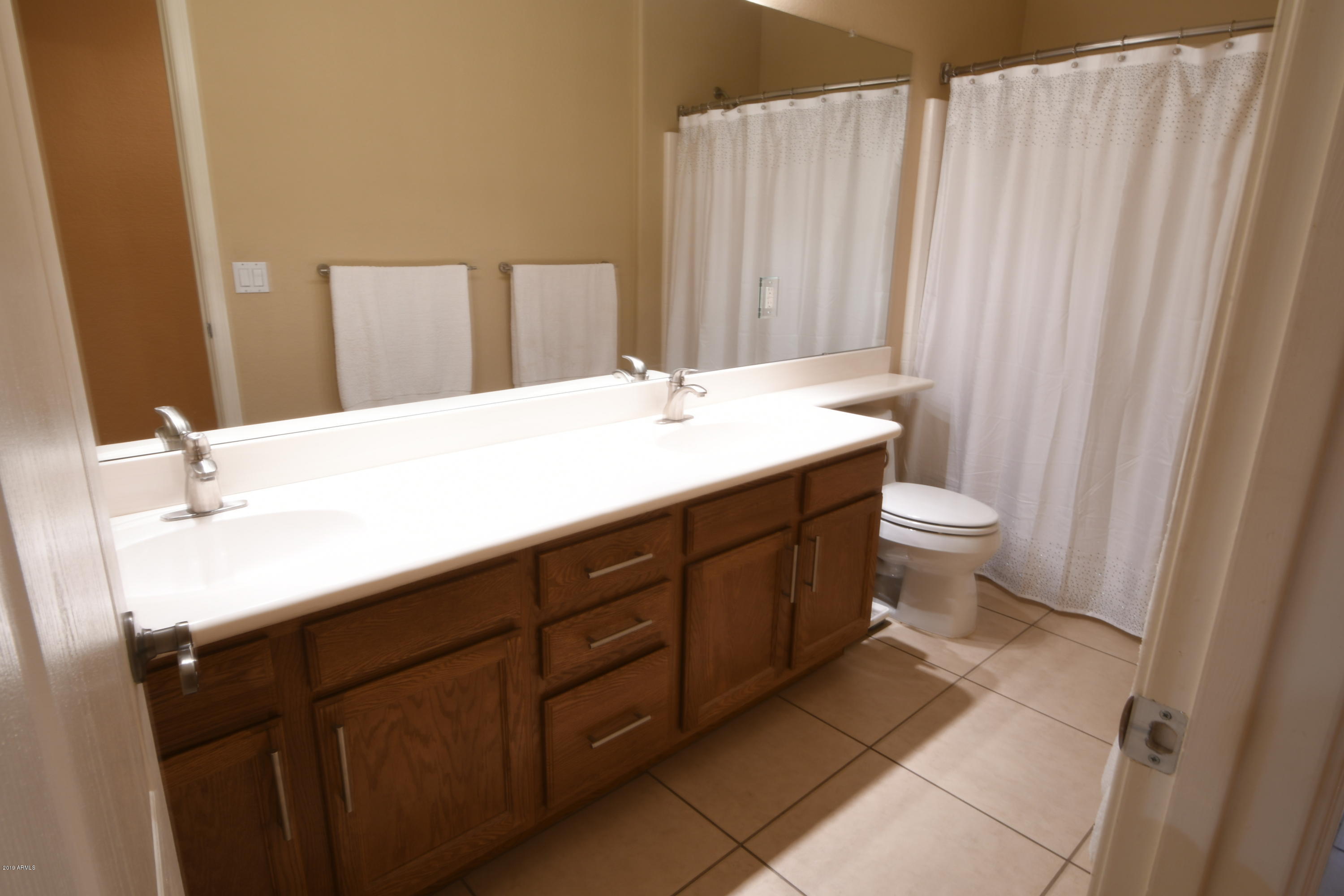 2226 West Carson Road Phoenix, AZ 85041 - Photo 22 of 29 a bathroom with a sink and a mirror