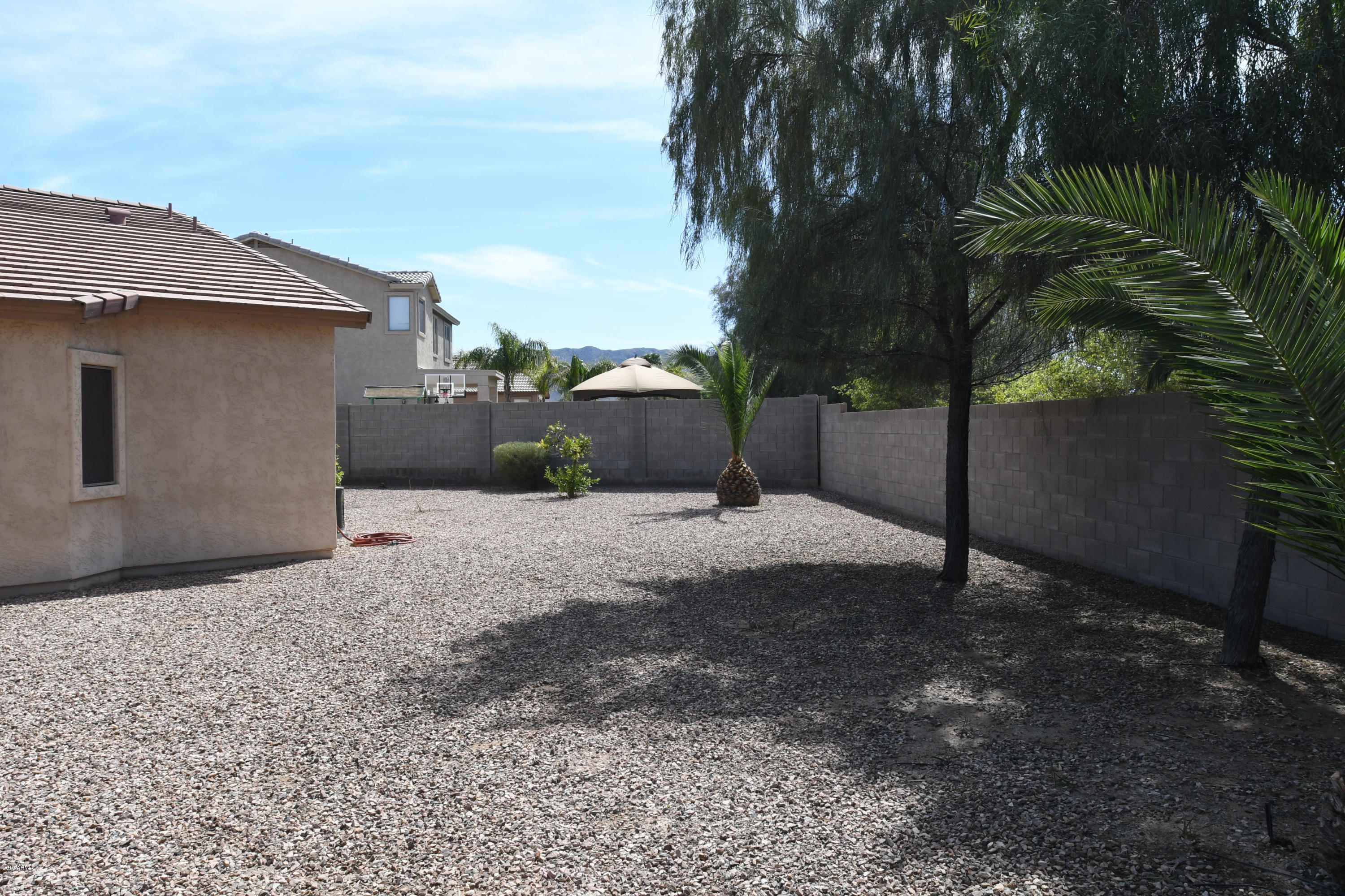 2226 West Carson Road Phoenix, AZ 85041 - Photo 28 of 29 a backyard of a house with potted plants