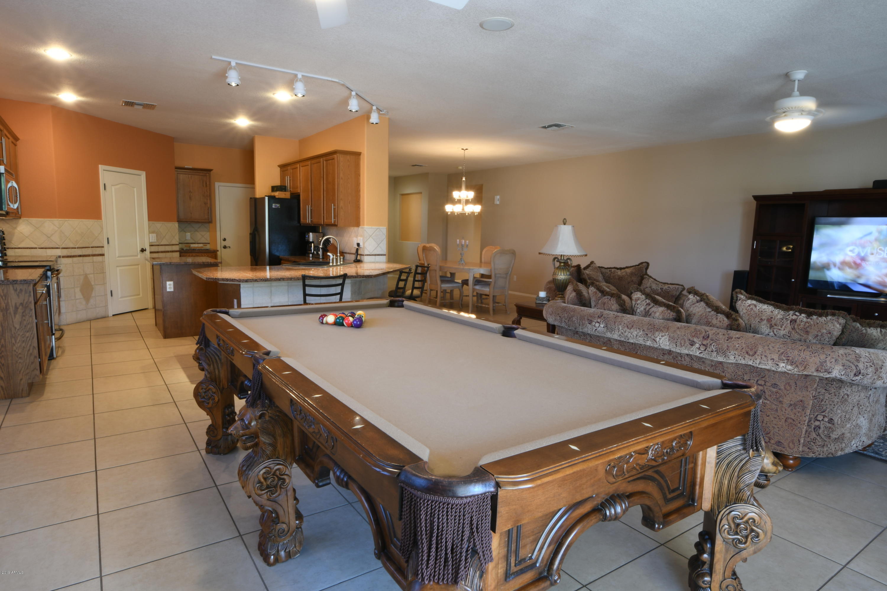 2226 West Carson Road Phoenix, AZ 85041 - Photo 4 of 29 a room with gym equipment and a flat screen tv