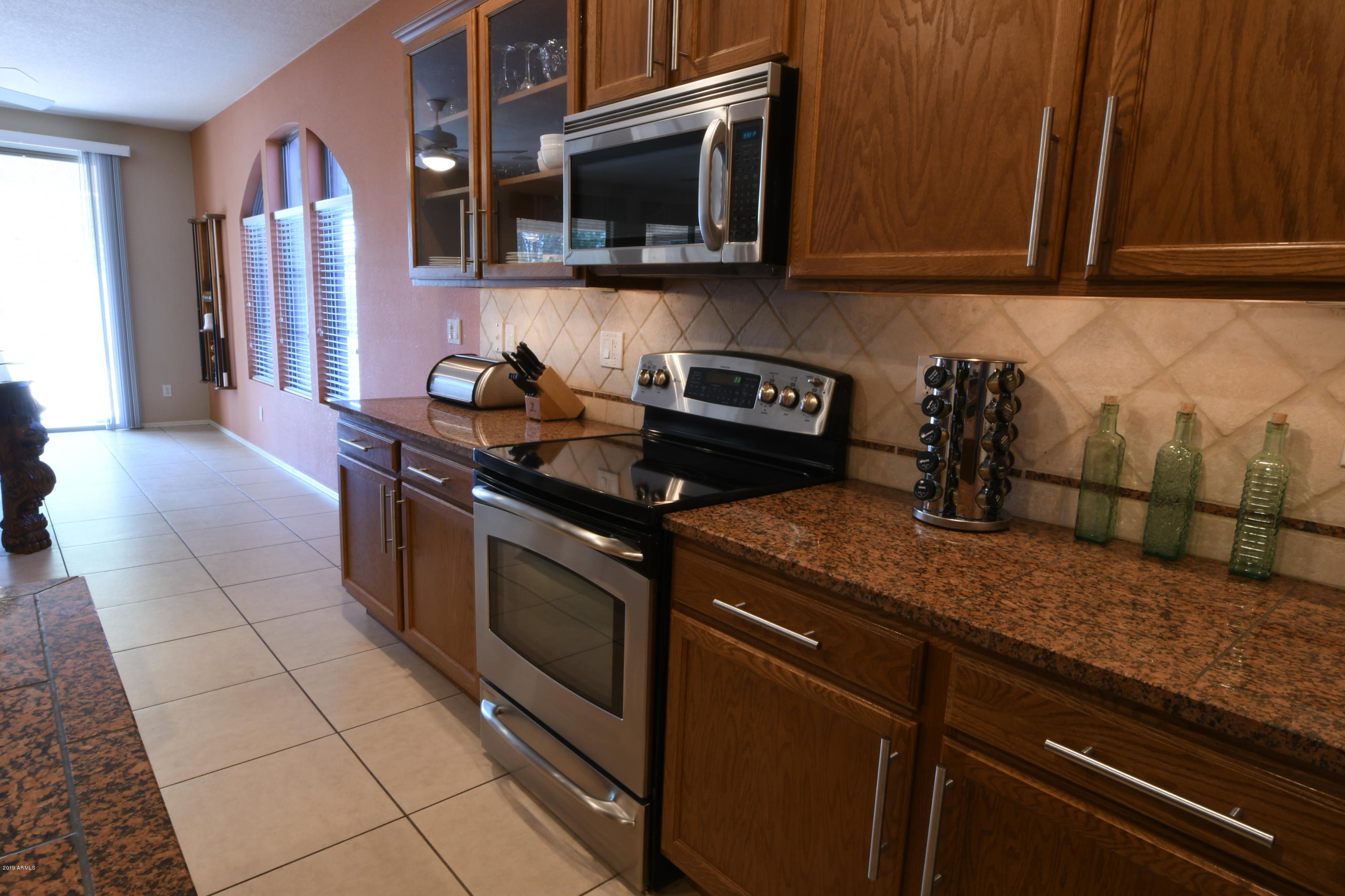2226 West Carson Road Phoenix, AZ 85041 - Photo 6 of 29 a kitchen with stainless steel appliances granite countertop a sink and a stove