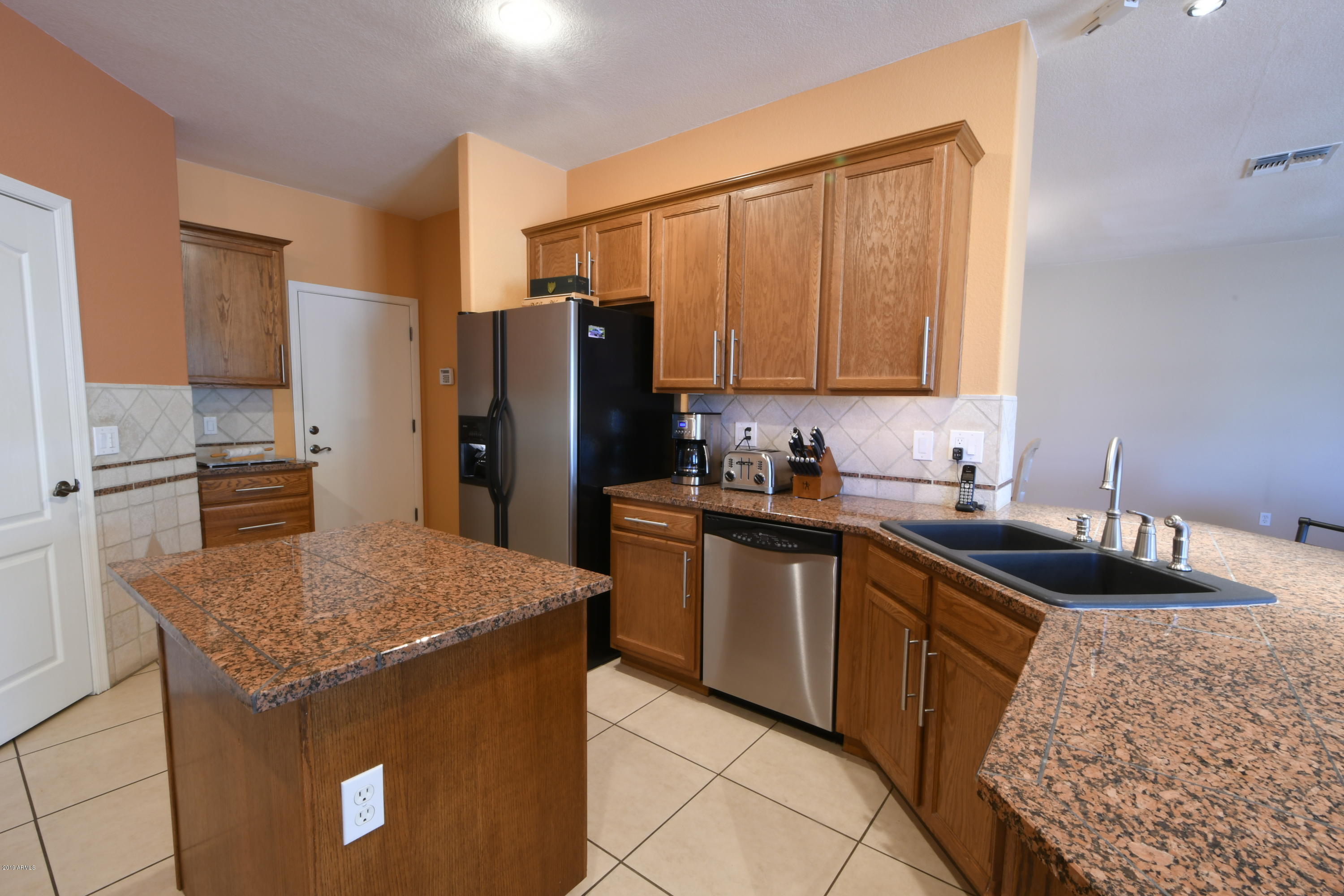2226 West Carson Road Phoenix, AZ 85041 - Photo 7 of 29 a kitchen with stainless steel appliances granite countertop a sink stove and refrigerator